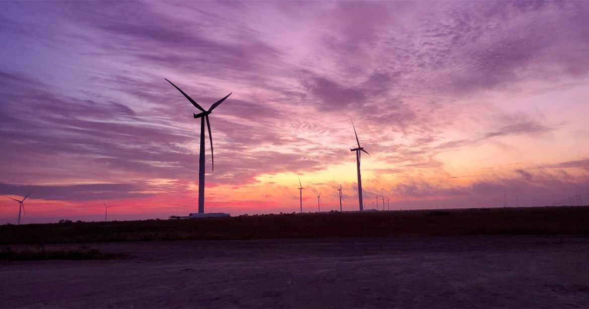 wind turbines against dusk sky