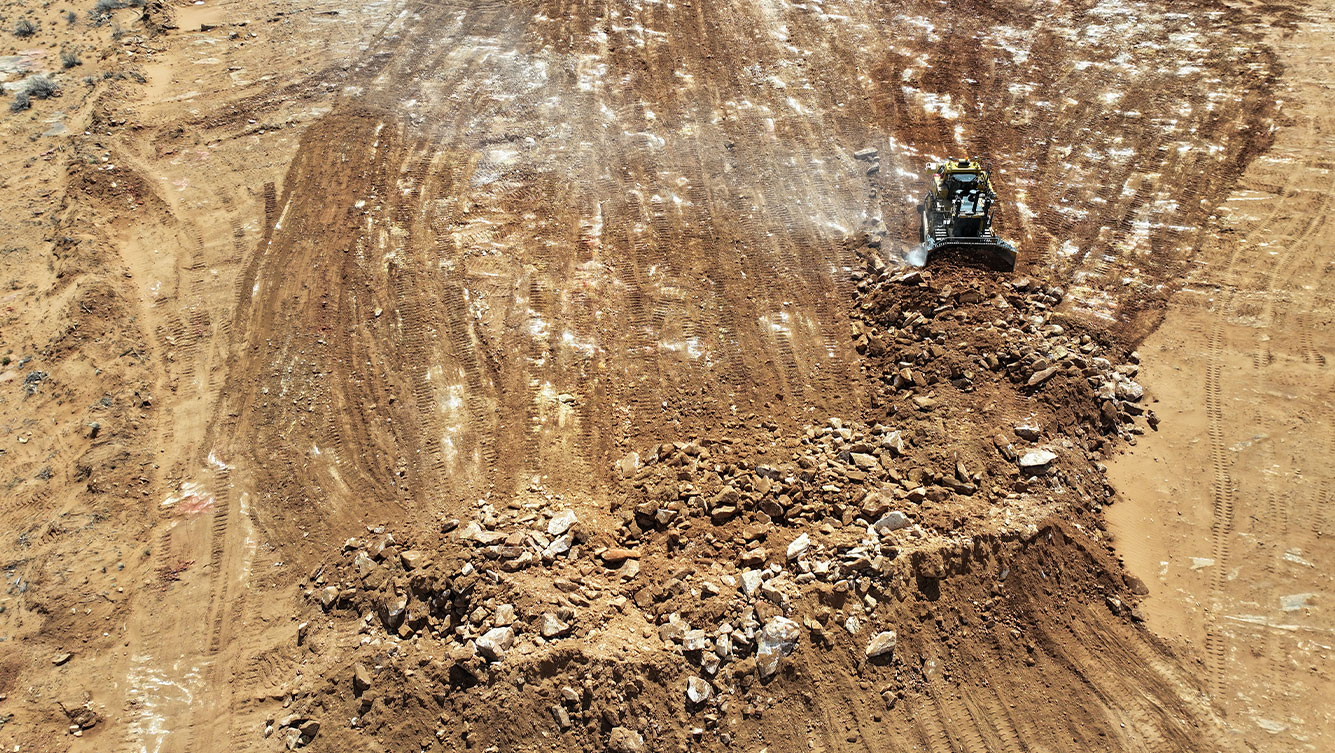 overhead view of bulldozer pushing dirt